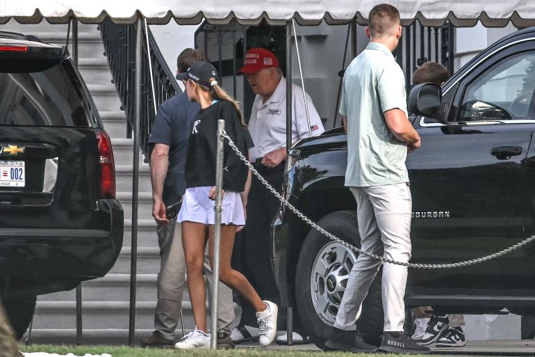US President Donald Trump (C) and his granddaughter Kai Trump (L) load the motorcade on the south lawn of the White House in Washington DC on August 30, 2025, as they head to Trump National golf course in Sterling, Virginia, (Photo by ANDREW CABALLERO-REYNOLDS / AFP)